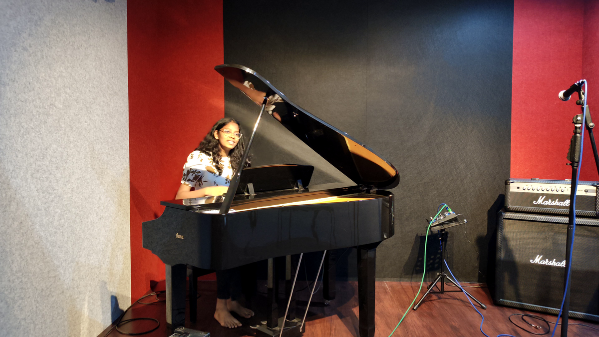Aurzart Music Academy student performing on a grand piano during a piano recital in Bangalore