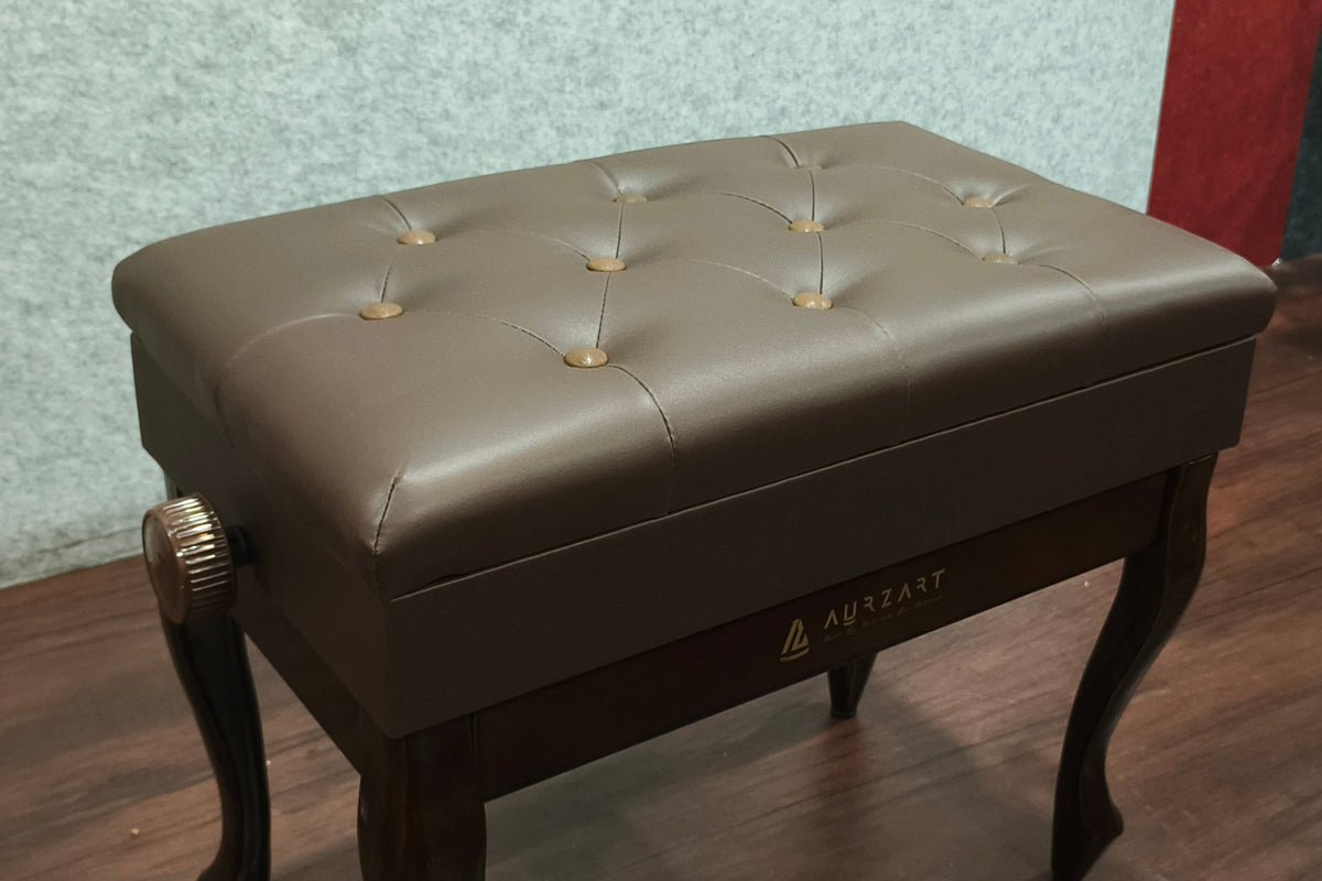 Brown leather bench with tufted design on a wooden floor.