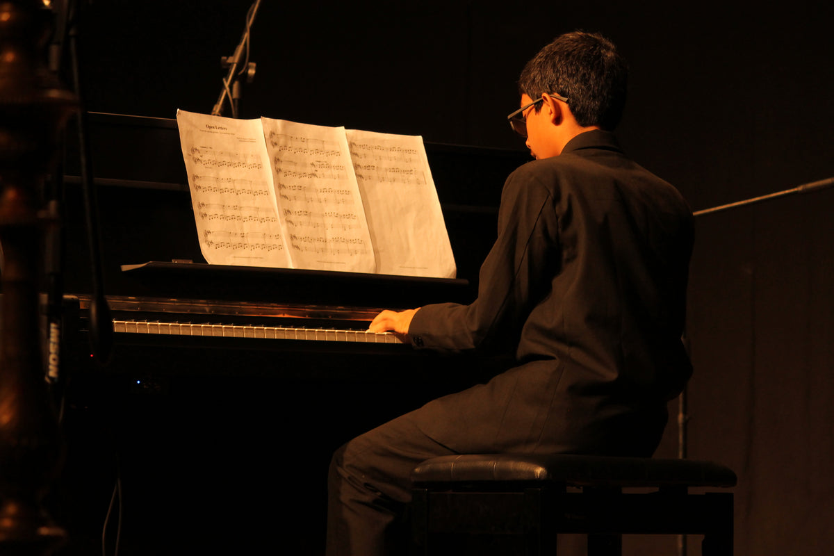 Aurzart Music Academy student performing on piano during a live recital in Bengaluru.
